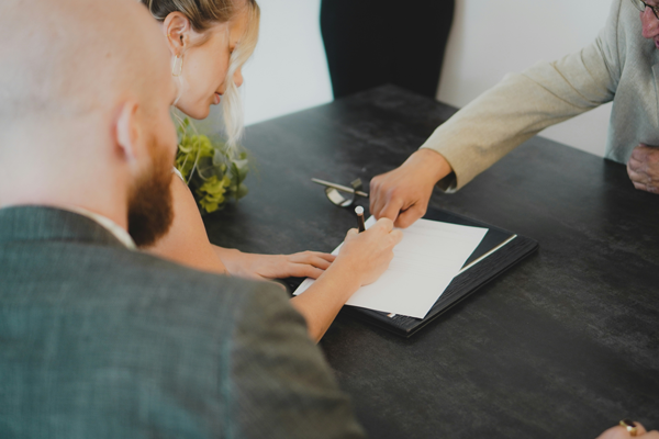 A business professional reviewing an agreement to purchase a cleaning business.